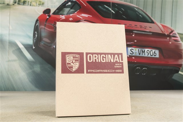 Leder-Dokumentenmappe in Rot mit geprägtem Porsche-Logo zur Aufbewahrung des Servicehefts und der Fahrerhandbücher.